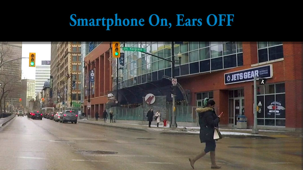Smartphone On - Ears Off! 7 Woman Walks Across Portage Ave Against Red Light while On Phone