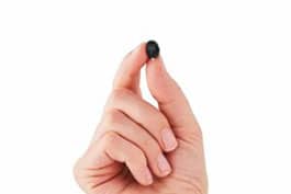 Home 4 Small Invisible Hearing Aids Held On FIngertips